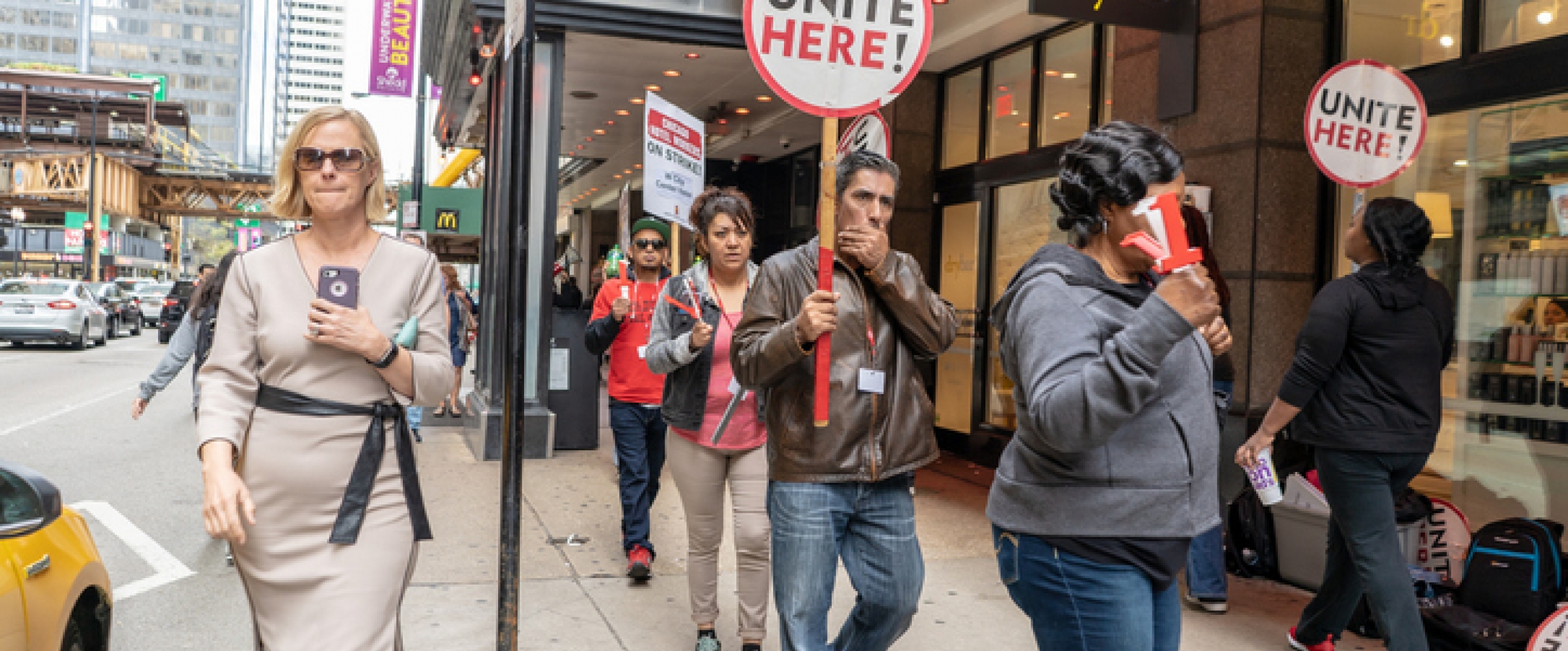 Chicago, IL / USA - September 10, 2018: People join a hotel workers' protest around Labor Day, carrying "Workers Unite" signs.